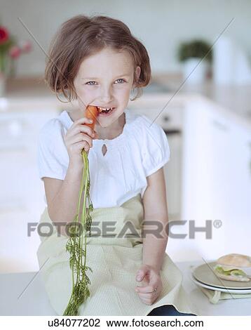 Young girl eating carrot View Large Photo Image Stock Image - Young girl eating carrot. Fotosearch