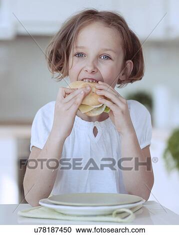 Young girl eating cheese sandwich View Large Photo Image Stock Image - Young girl eating cheese sandwich. Fotosearch