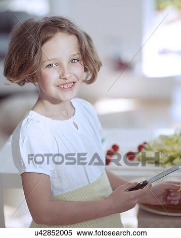 Young girl holding knife in kitchen View Large Photo Image Stock Photography - Young girl holding knife in kitchen . Fotosearch