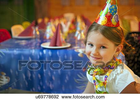 Young girl seated at her birthday table View Large Photo Image Stock Image - Young girl seated at her birthday table. Fotosearch