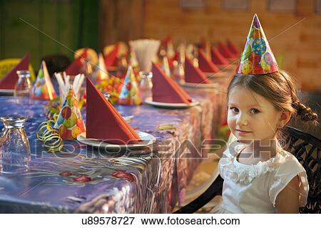 Young girl seated at her birthday table View Large Photo Image Stock Photo - Young girl seated at her birthday table. Fotosearch