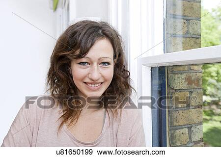 Young woman in trendy office looking at camera and smiling View Large Photo Image Stock Photo - Young woman in trendy office looking at camera and smiling. Fotosearch