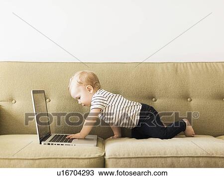 Baby girl (12-17 months) using laptop View Large Photo Image Stock Image - Baby girl (12-17 months) using laptop. Fotosearch