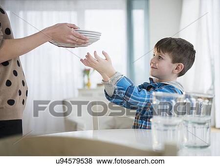 Boy (4-5) helping mother to set table View Large Photo Image Stock Photo - Boy (4-5) helping mother to set table. Fotosearch