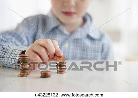 Boy (4-5) stacking coins View Large Photo Image Stock Image - Boy (4-5) stacking coins. Fotosearch