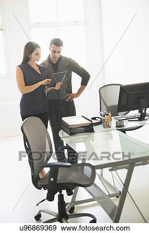 Stock Photo - Business people working in office. Fotosearch