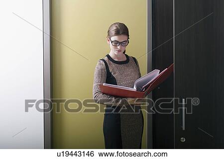 Stock Photograph - Businesswoman reading files. Fotosearch