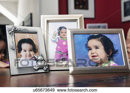 Children's (6-11 months) portraits in frames on table View Large Photo Image Stock Photo - Children's (6-11 months) portraits in frames on table . Fotosearch