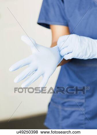 Close-up of nurses hands-putting on surgical gloves View Large Photo Image Stock Photo - Close-up of nurses hands-putting on surgical gloves. Fotosearch