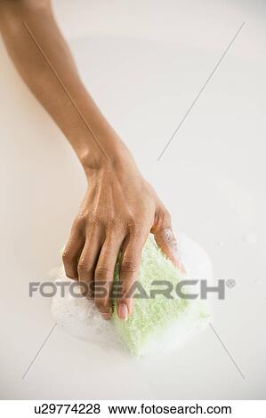 Close up of woman's hand cleaning with sponge View Large Photo Image Stock Photo - Close up of woman's hand cleaning with sponge. Fotosearch
