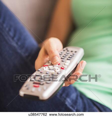 Close up of woman's hand holding remote control View Large Photo Image Stock Image - Close up of woman's hand holding remote control. Fotosearch