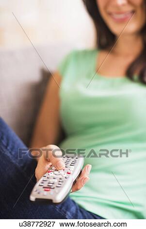 Close up of woman's hand holding remote control View Large Photo Image Stock Photo - Close up of woman's hand holding remote control. Fotosearch