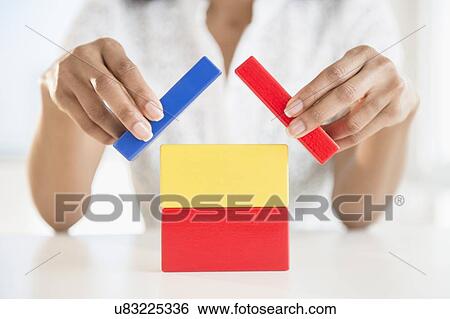 Close up of woman's hands holding blocks View Large Photo Image Stock Photograph - Close up of woman's hands holding blocks. Fotosearch