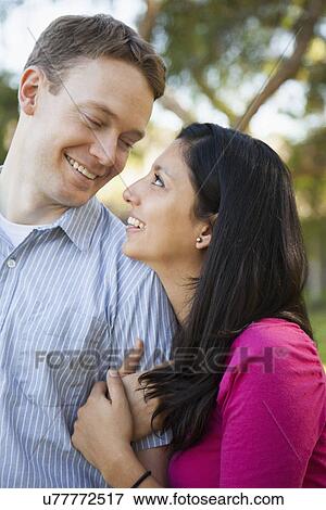 Couple embracing in park View Large Photo Image Stock Photo - Couple embracing in park. Fotosearch