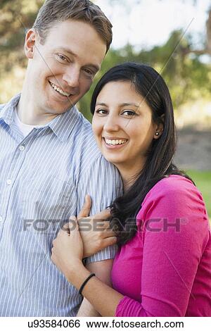 Stock Photograph - Couple embracing in park. Fotosearch