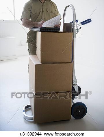 Delivery man filling documents View Large Photo Image Picture - Delivery man filling documents. Fotosearch