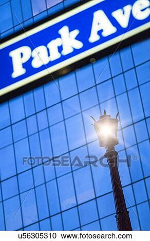 Stock Image - Detail of Park Avenue sign with street lamp. Fotosearch
