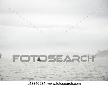 Distant view of people in boat View Large Photo Image Picture - Distant view of people in boat. Fotosearch
