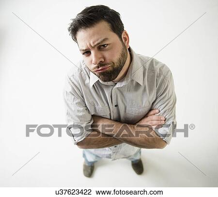 Elevated view of irritated man, arms crossed View Large Photo Image Stock Image - Elevated view of irritated man, arms crossed. Fotosearch