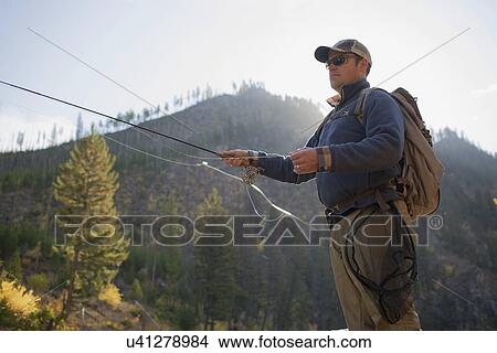 Fisherman in front of mountain View Large Photo Image Picture - Fisherman in front of mountain. Fotosearch