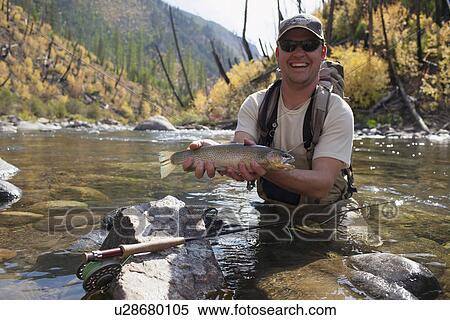 Fisherman showing fresh trout View Large Photo Image Stock Photography - Fisherman showing fresh trout. Fotosearch