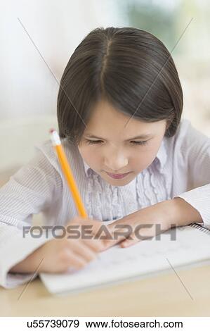 Girl (8-9) doing homework View Large Photo Image Stock Photo - Girl (8-9) doing homework. Fotosearch