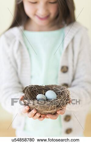 Girl (8-9) holding bird's nest with eggs View Large Photo Image Stock Image - Girl (8-9) holding bird's nest with eggs. Fotosearch