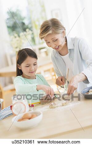 Granddaughter (8-9) cooking with grandmother View Large Photo Image Stock Image - Granddaughter (8-9) cooking with grandmother. Fotosearch