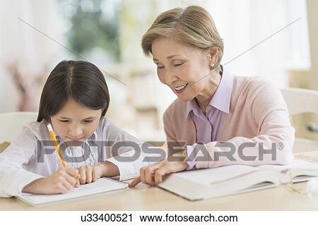 Grandmother and granddaughter (8-9) doing homework View Large Photo Image Stock Image - Grandmother and granddaughter (8-9) doing homework. Fotosearch