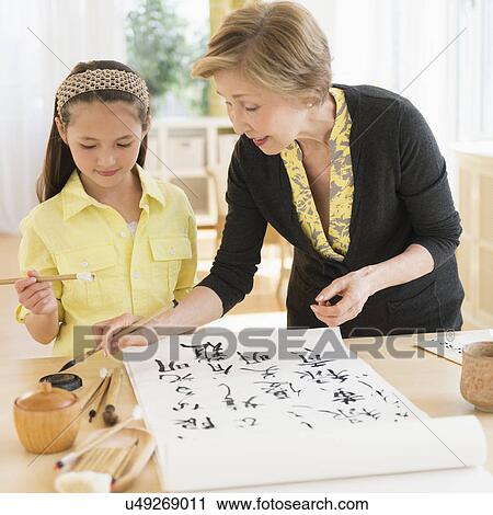 Grandmother and granddaughter (8-9) painting japanese symbols View Large Photo Image Stock Image - Grandmother and granddaughter (8-9) painting japanese symbols. Fotosearch