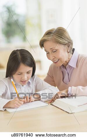 Grandmother and granddaughter (8-9) doing homework View Large Photo Image Stock Image - Grandmother and granddaughter (8-9) doing homework. Fotosearch
