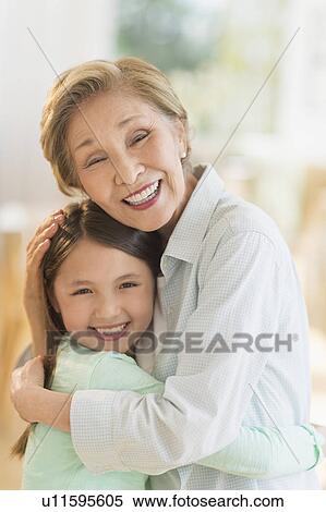 Grandmother embracing granddaughter (8-9) View Large Photo Image Stock Photography - Grandmother embracing granddaughter (8-9). Fotosearch