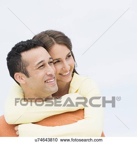 Stock Image - Happy young couple embracing. Fotosearch