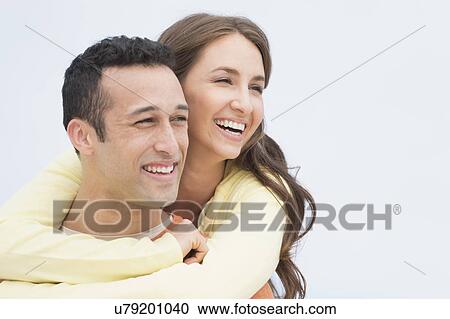 Happy young couple embracing View Large Photo Image Stock Image - Happy young couple embracing. Fotosearch