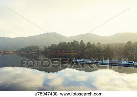 Stock Photo - Landscape with sky reflected in water. Fotosearch