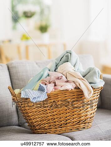 Stock Photo - Laundry basket on sofa. Fotosearch