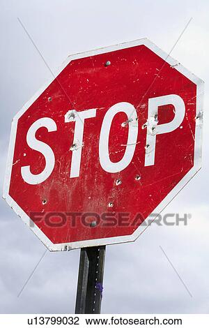 Low angle view of stop sign with bullet holes View Large Photo Image Stock Image - Low angle view of stop sign with bullet holes. Fotosearch