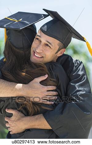 Male and female students embracing on graduation ceremony View Large Photo Image Stock Image - Male and female students embracing on graduation ceremony. Fotosearch