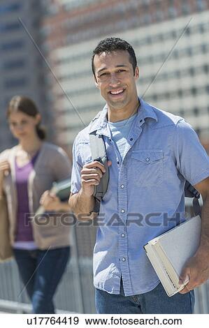 Stock Photo - Male and female students in campus. Fotosearch