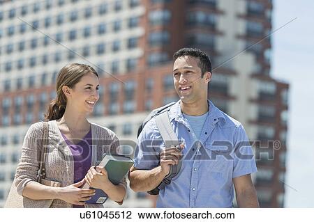 Male and female students walking in campus View Large Photo Image Stock Image - Male and female students walking in campus. Fotosearch