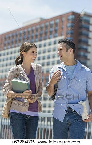 Male and female students walking in campus View Large Photo Image Stock Photography - Male and female students walking in campus. Fotosearch