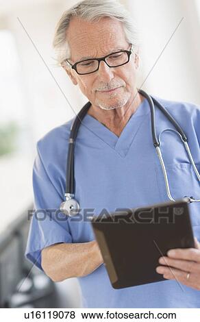 Male doctor using digital tablet View Large Photo Image Stock Photo - Male doctor using digital tablet. Fotosearch