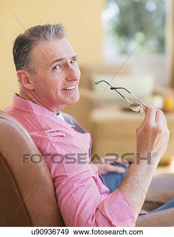 Man holding spectacles View Large Photo Image Stock Photo - Man holding spectacles . Fotosearch