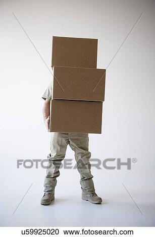 Stock Image - Man holding stack of boxes. Fotosearch