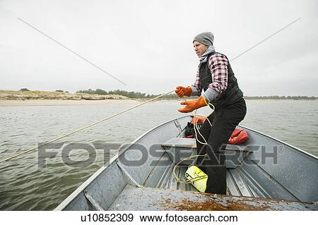Man pulling net full of crabs View Large Photo Image Stock Photo - Man pulling net full of crabs. Fotosearch