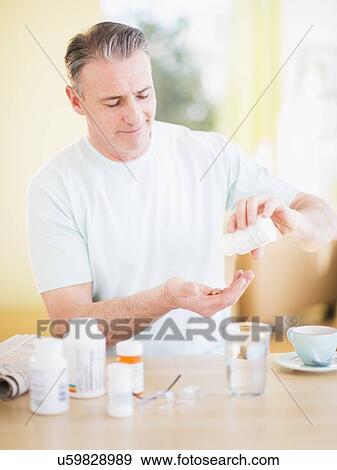 Stock Photo - Man taking medicine. Fotosearch