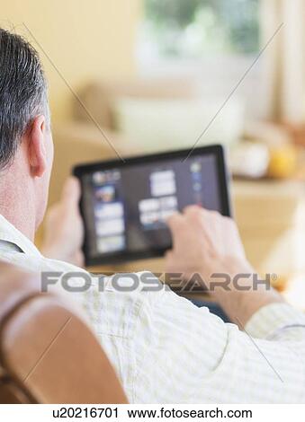 Stock Image - Man using digital tablet. Fotosearch