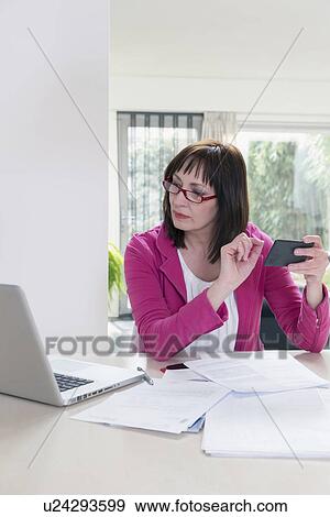 Stock Photo - Mature businesswoman doing paperwork. Fotosearch
