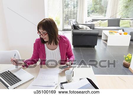 Mature businesswoman doing paperwork View Large Photo Image Stock Photo - Mature businesswoman doing paperwork. Fotosearch