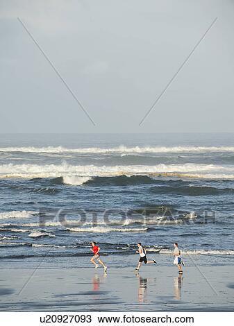 Men running on beach View Large Photo Image Stock Image - Men running on beach. Fotosearch